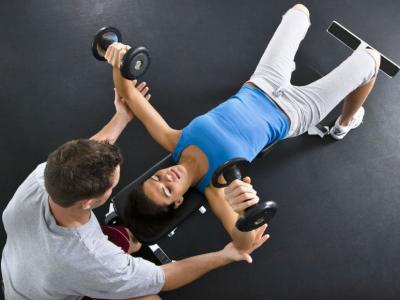 homem ajuda a mulher no exercício físico